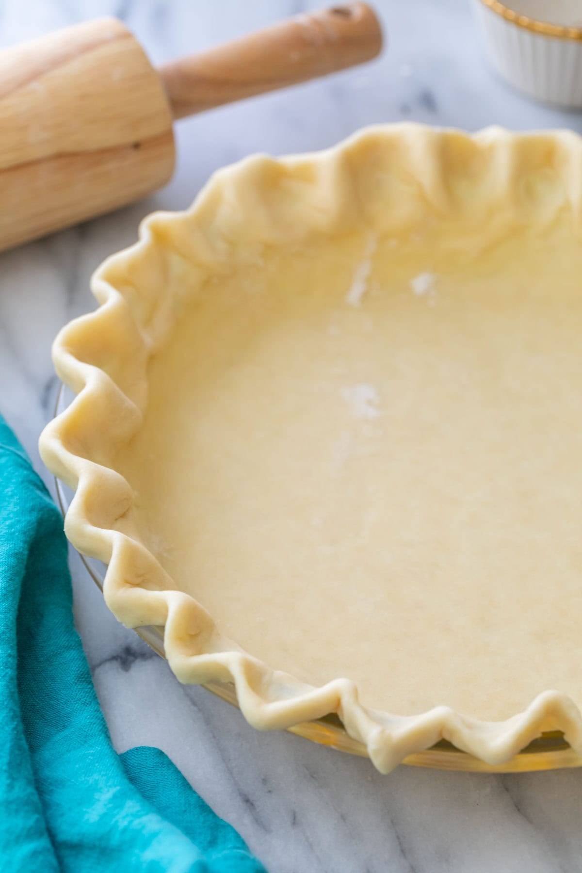 Close-up view of a fluted pie crust made from an easy pie crust recipe. 